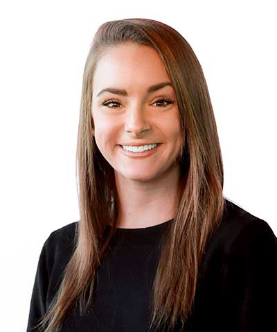 A smiling woman with long brown hair, who is part of an event planning company, wearing a black top against a white background.