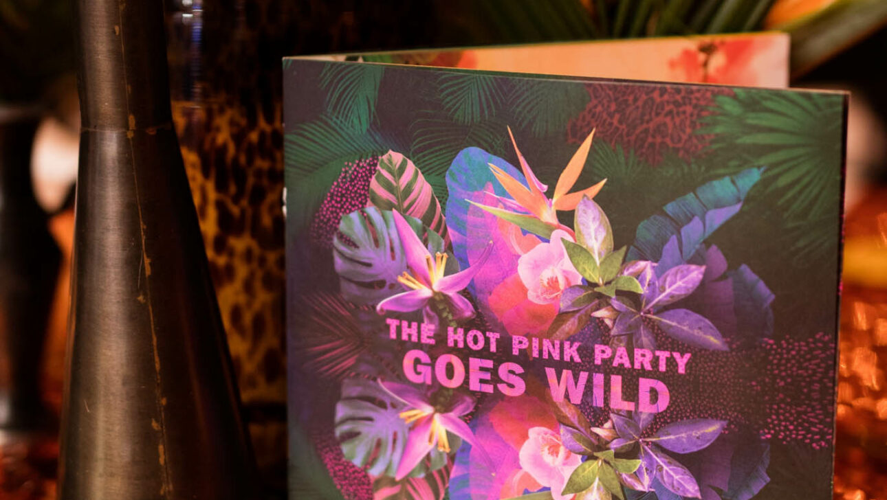 card on table that says hot pink party goes wild.