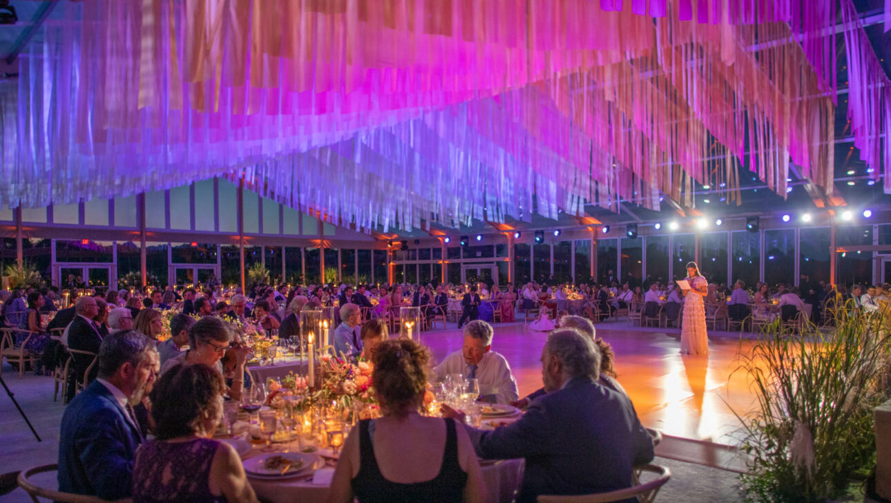wedding hall decorated with blue and purple hanging fabric.