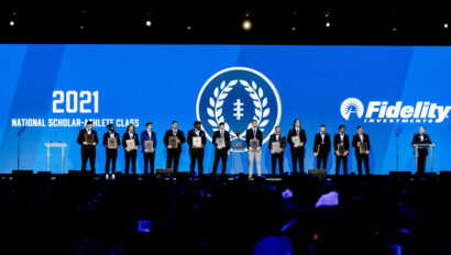 stage of men holding plaques in front of screen that says 2021 national scholar atheletes.