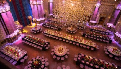 overhead view of a dining hall decorated for a party with a large chandelier.