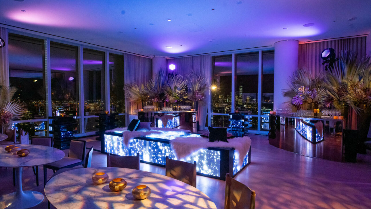 neon lit tropical decorated club space in a highrise building.