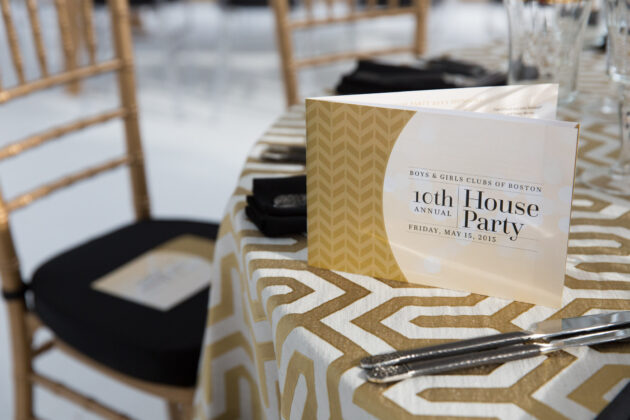 Elegant table setting for a formal event, organized by top-notch event planners, with a program for the "10th annual house party" for the Boys & Girls Clubs of Boston.