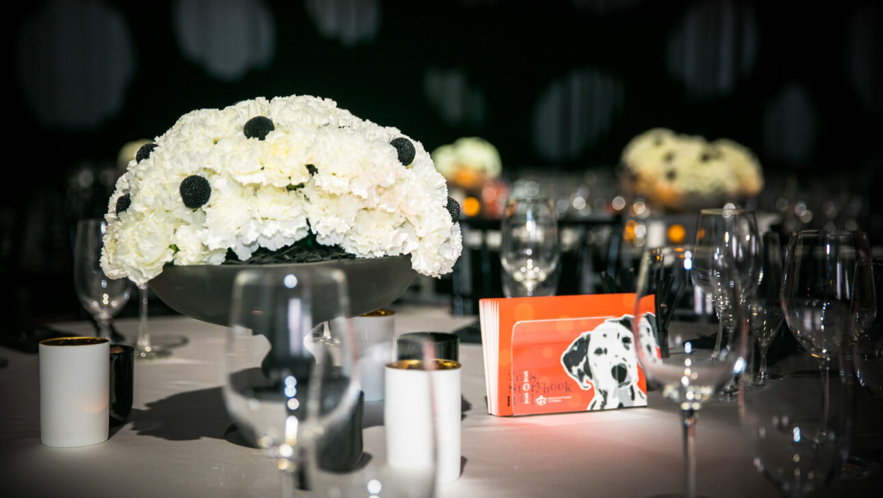 decorated table place setting with a card for the 2018 storybook ball.