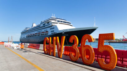 cruise ship docked behind a sign that says chv 365.