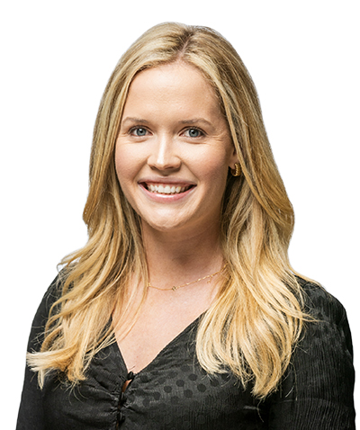 A smiling woman with blonde hair, working for an event planning company, wearing a black top against a white background.