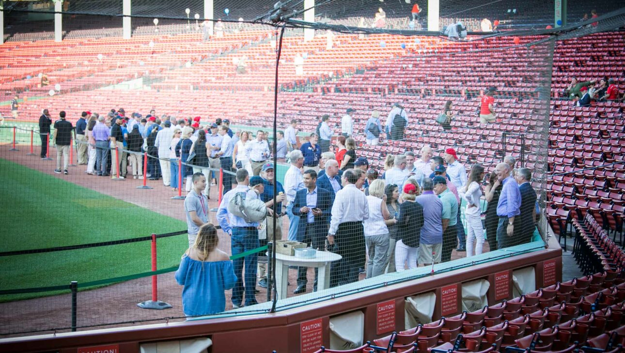 corporate guests socializing on the field at fenway park.