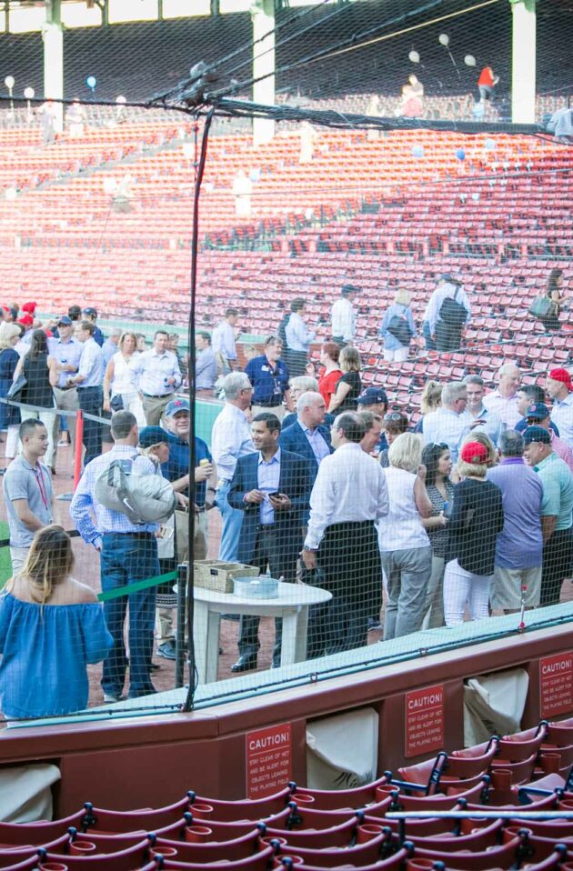 corporate guests socializing on the field at fenway park.