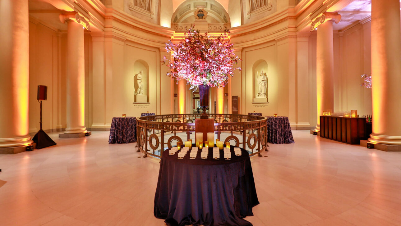 place cards set on a table in a large rotunda room.