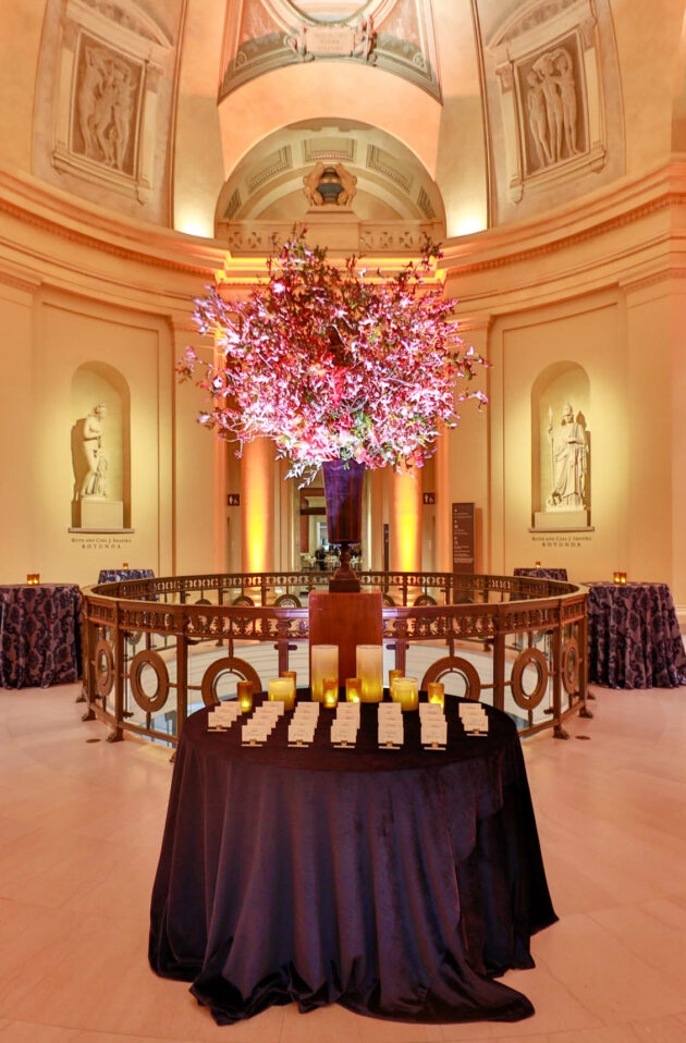 place cards set on a table in a large rotunda room.