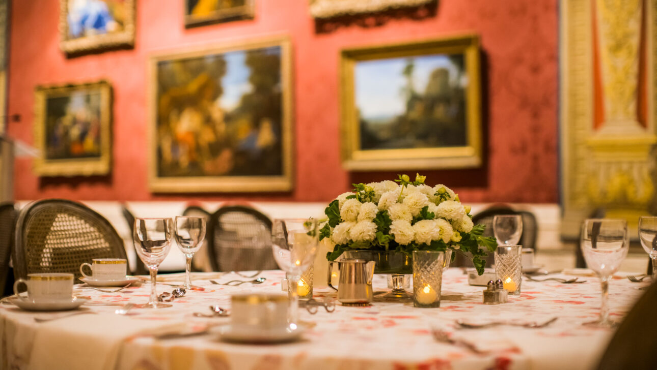 decorated dining table in a museum exhibit room.