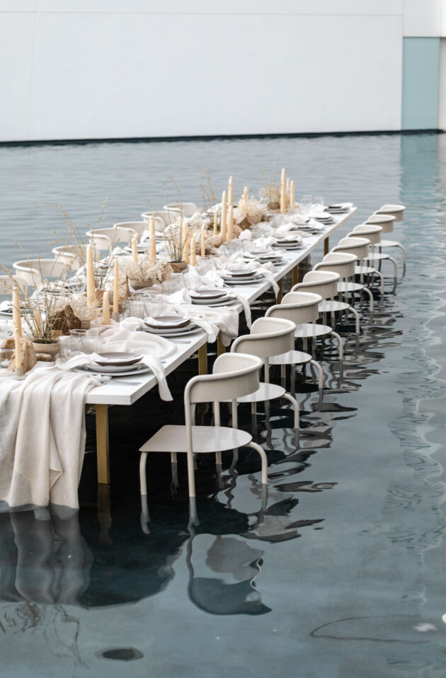 decorated dining table and chairs in a foot of water.