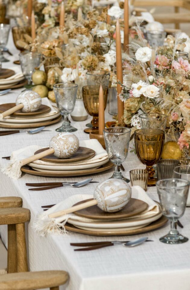 Elegant table setting with floral arrangements and gold accents for a formal event, meticulously organized by a top event planning company.