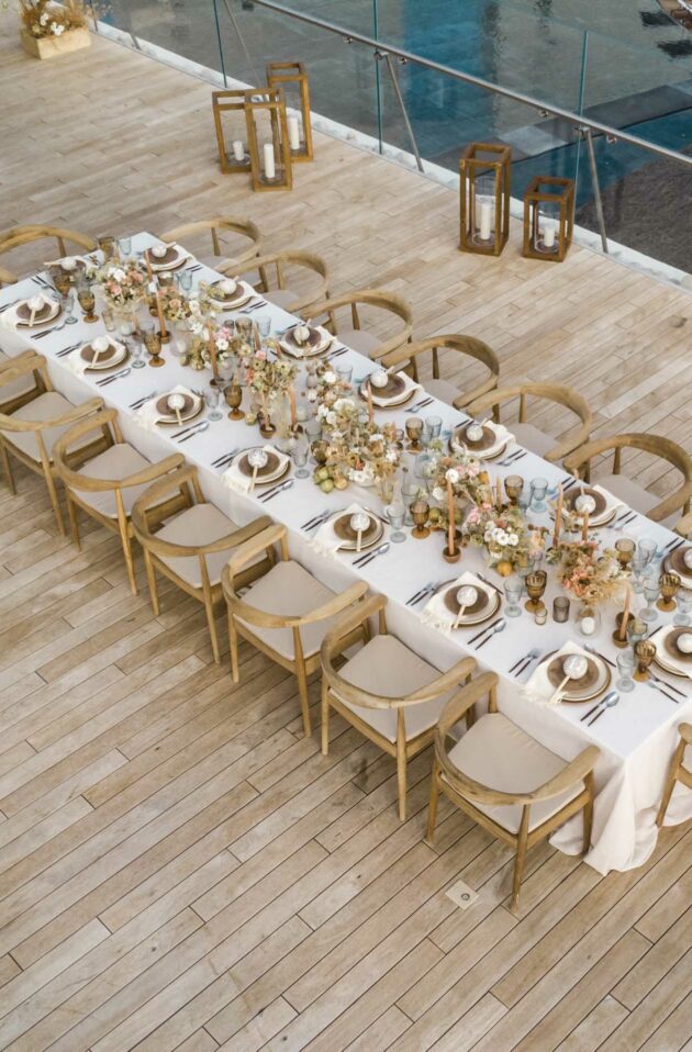 decorated dining table outside on a dock.