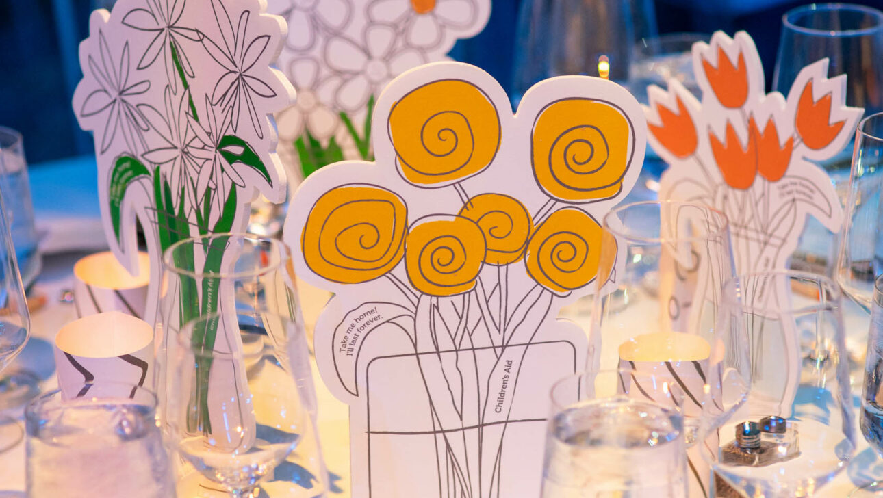hand drawn dinner centerpieces on a dining table.