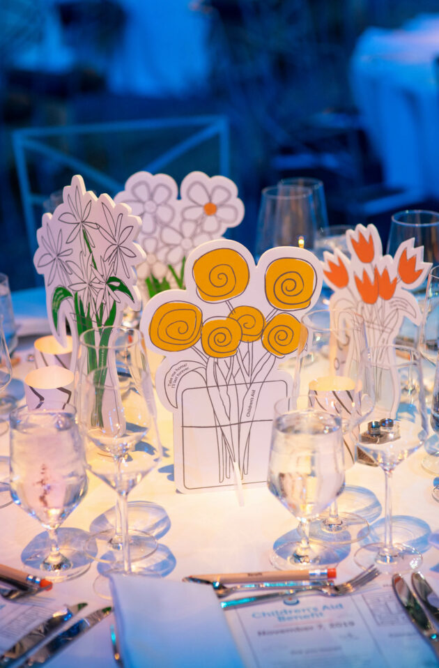 hand drawn dinner centerpieces on a dining table.