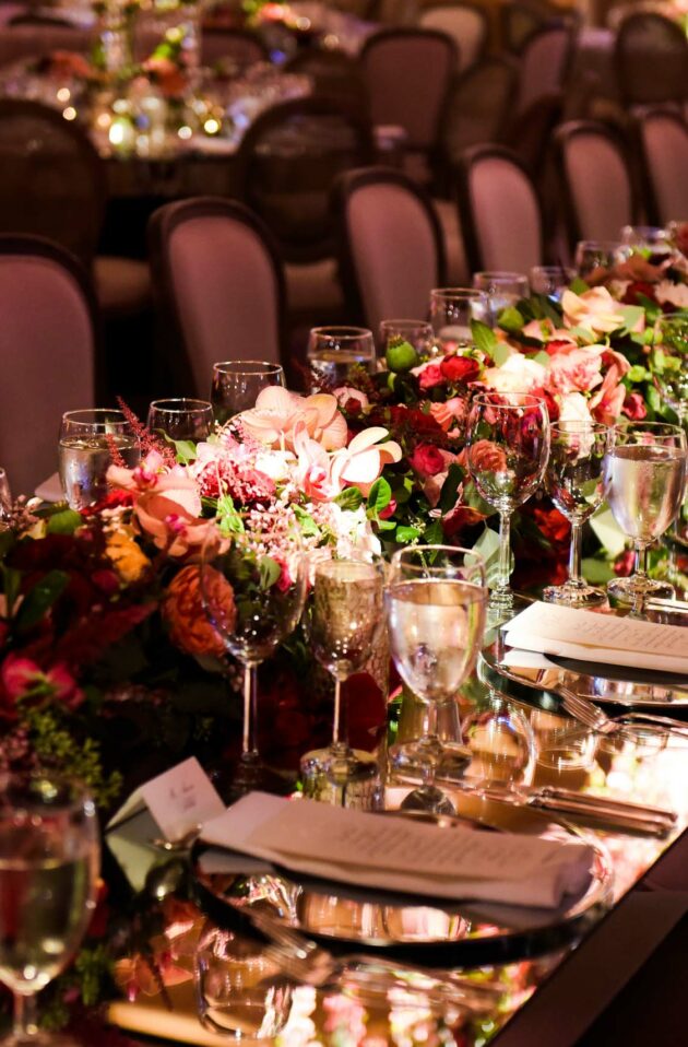 decorated dining table with floral arrangement centerpieces.