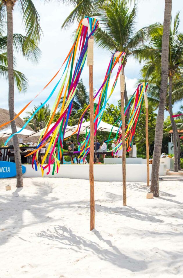colorful streamers on poles on the beach.