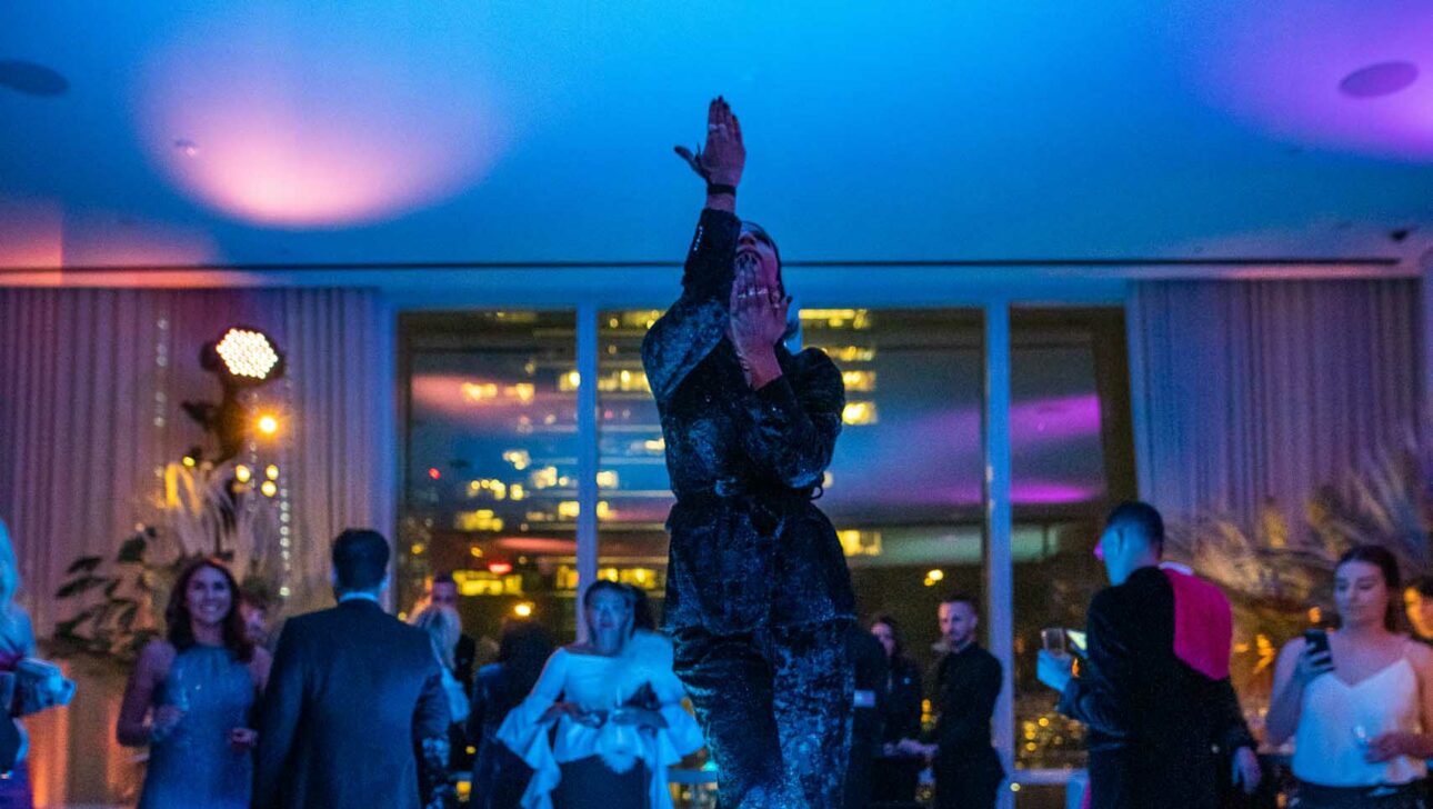 woman dancing on a videoboard table at a party.