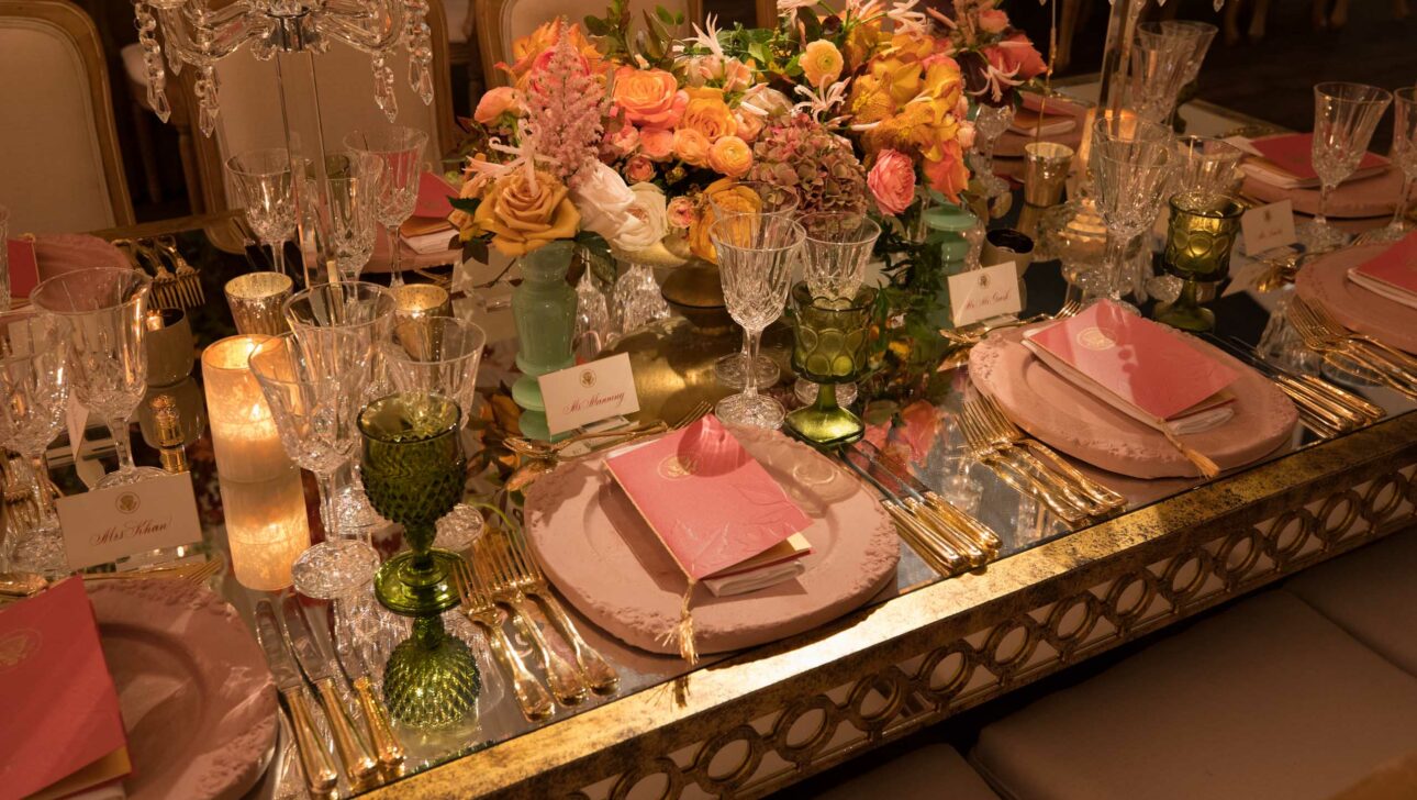 decorated place settings with floral table centerpieces.