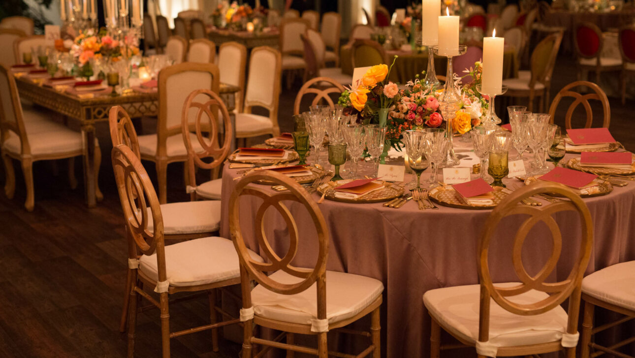 decorated dining tables with chairs and candle and floral centerpieces.