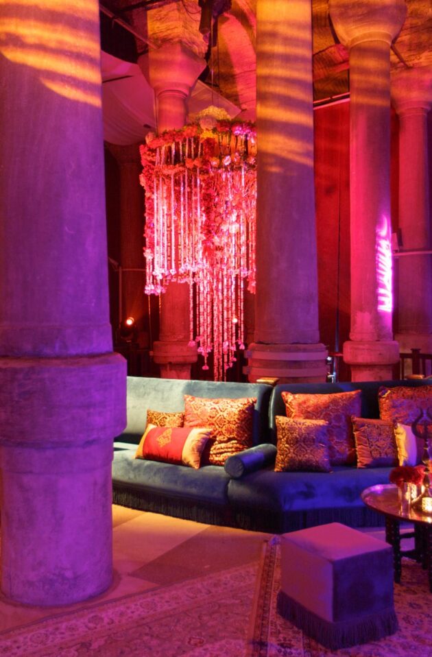neon pink and purple lit lounge in a room full of columns.