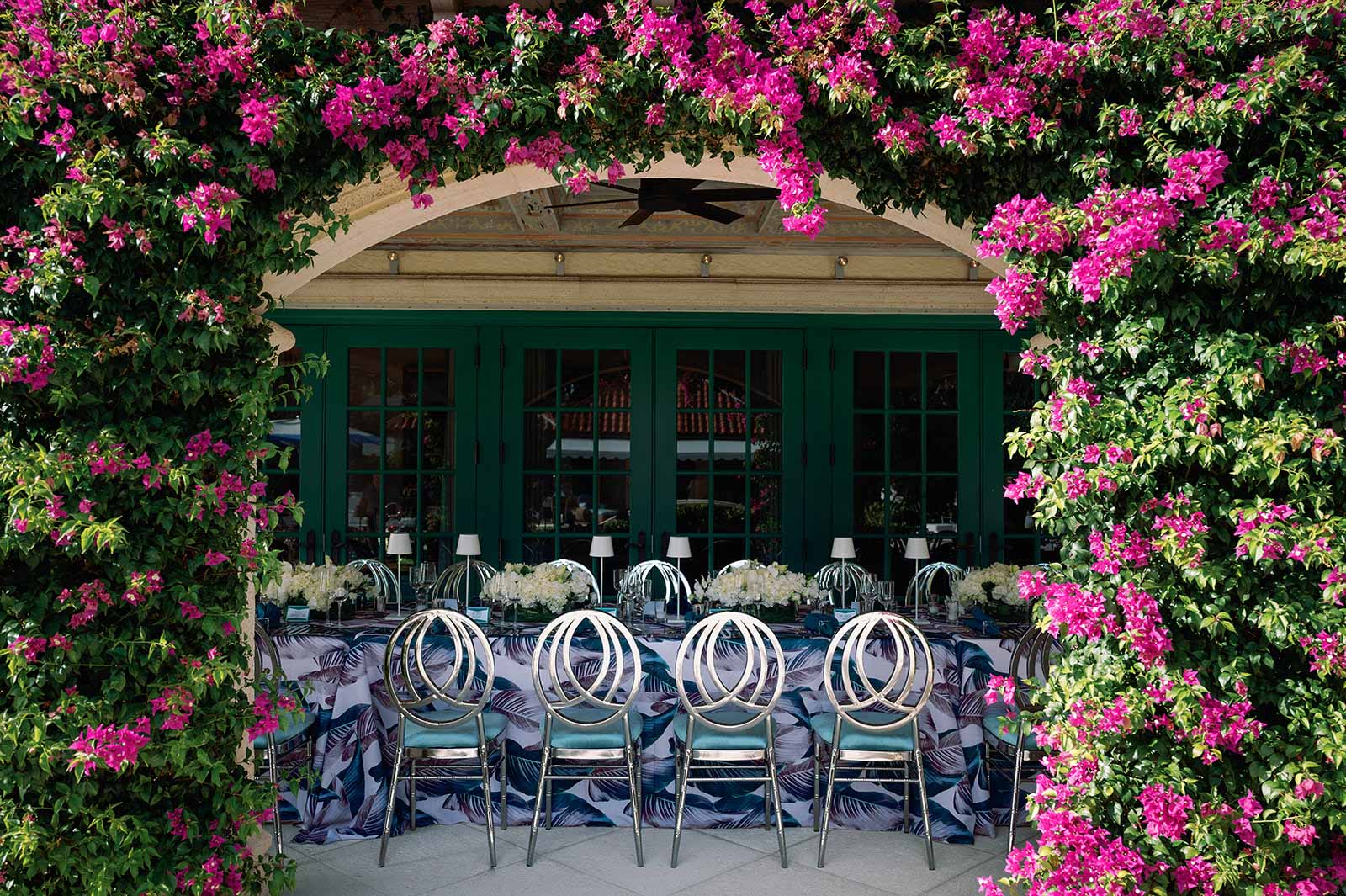 pink flower arch over a decorated table.