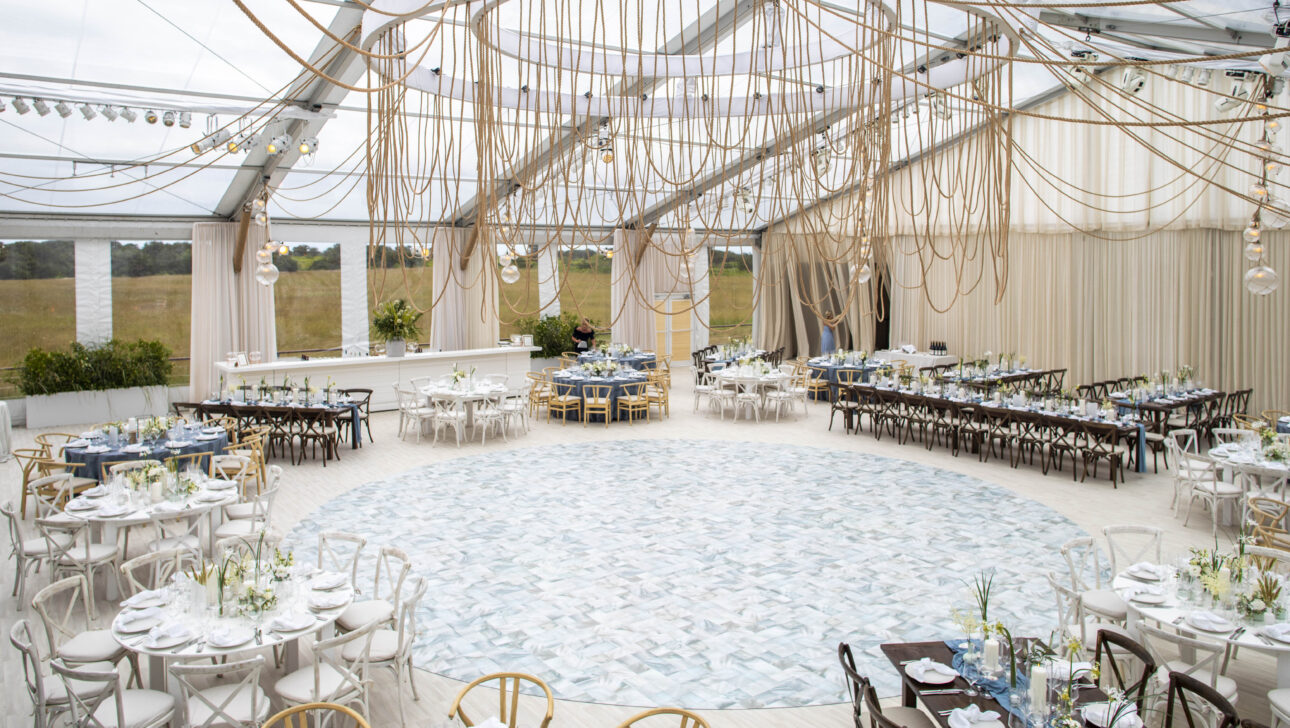 Wedding reception with custom nautical rope ceiling installation. Designed by Rafanelli Events.