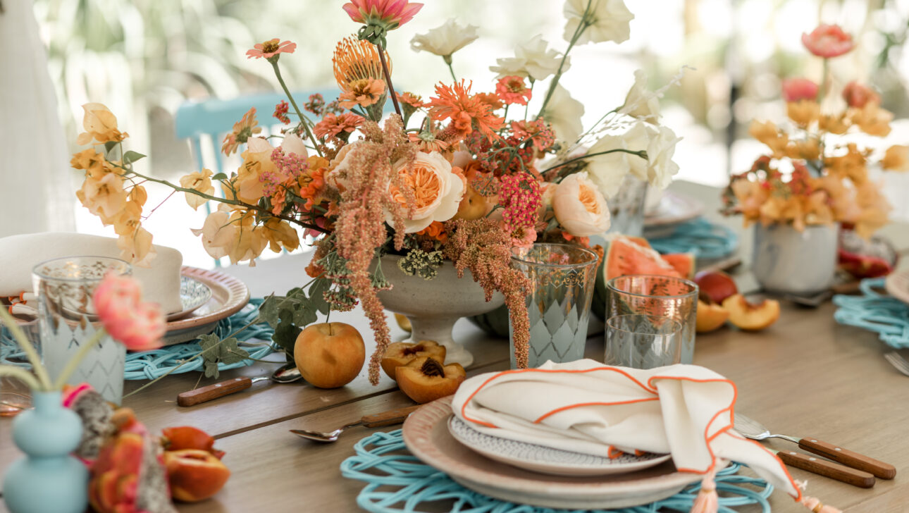 Viceroy Los Cabos Destination Wedding Reception table with colorful pink and orange florals. Designed by Rafanelli Events.
