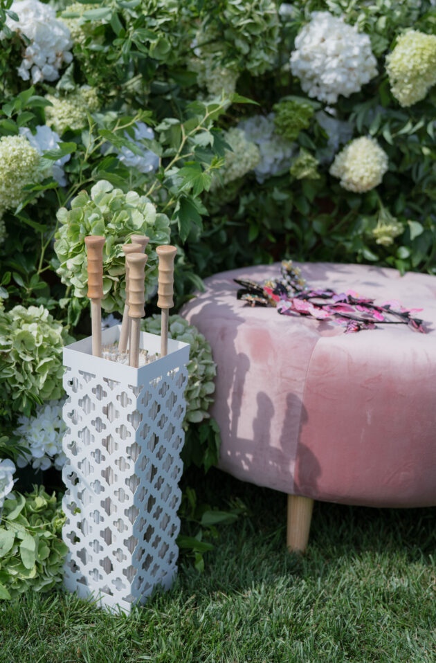 Martha's Vineyard Destination Wedding Ceremony Decor. Pink velvet seating and umbrellas for guests. Designed by Rafanelli Events.
