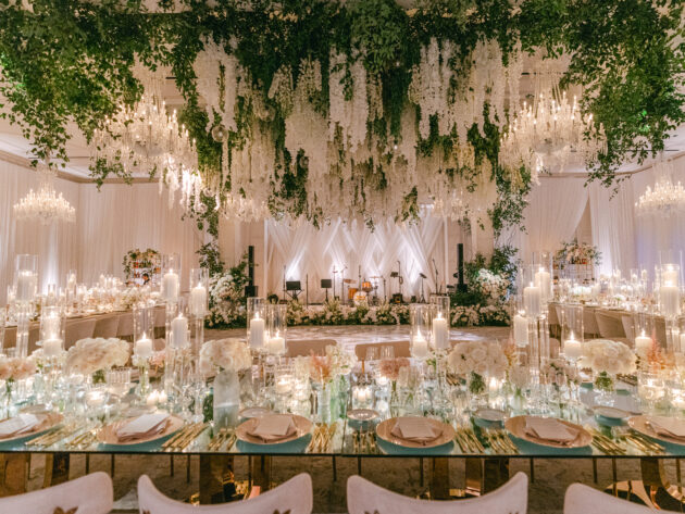 Dramatic wedding reception under a canopy of beautiful white florals. Designed by Rafanelli Events.
