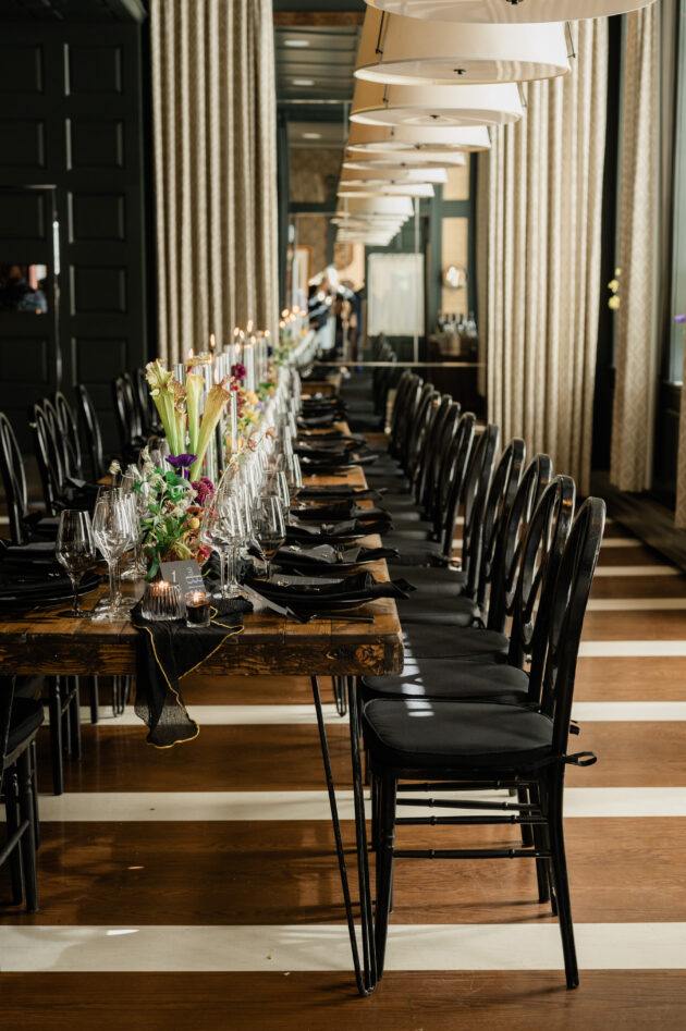 Private dinner setting with dark tones and black.